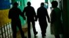 FILE - Residents walk along a corridor after lunch time in a facility for people with mental and physical disabilities in the village of Tavriiske, Ukraine, May 10, 2022. 