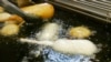FILE - A candy bar is deep-fried in oil free of trans fats at a food booth at the Indiana State Fair in Indianapolis, Aug. 8, 2007. 
