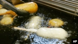 FILE - A candy bar is deep-fried in oil free of trans fats at a food booth at the Indiana State Fair in Indianapolis, Aug. 8, 2007. 