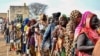 Women who fled the war-torn Sudan queue to receive food rations at the United Nations High Commissioner for Refugees transit center in Renk, near the border crossing point in Renk County of Upper Nile State, South Sudan May 1, 2023. 