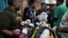 Palestinian children wounded in the Israeli bombardment of the Gaza Strip are brought to the hospital in Deir al Balah, Gaza Strip, Dec. 11, 2023. 