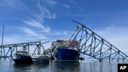 FILE - The fallen Francis Scott Key Bridge in Baltimore, Maryland, March 31, 2024. The cargo ship that caused the bridge collapse remained stuck amid the wreckage for almost two months.