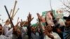 Supporters of former Pakistani Prime Minister Imran Khan chant slogans, after police postpone the arrest of Khan, outside his home in Lahore, Pakistan, March 15, 2023. 
