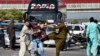 FILE - Plainclothes police officers beat a supporter of Pakistan's former Prime Minister Imran Khan during a protest to condemn the arrest of their leader in Peshawar, May 9, 2023. 