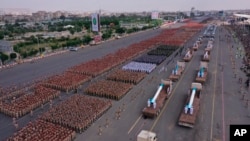 A military parade displaying Houthi forces and weapons moves through a main street of Sanaa, Yemen, on Sept. 21, 2022. Yemen's warring parties faced a deadline to renew a 6-month-long truce on Sunday, Oct. 2. 