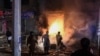 Onlookers gather near the site of an explosion, which killed three people and wounded several others according to media reports, at a market area in Quetta on March 2, 2022. 