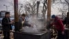 Ukrainian volunteers prepare food for displaced people outside Lviv railway station, in Lviv, western Ukraine, March 3, 2022.