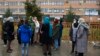 Members of Afghanistan's Powerful Women Movement gather outside Jamhuriat Hospital in Kabul on March 8, 2022, after Taliban officials prohibited them from donating blood. 