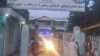 Taliban fighters and medical staff stand outside the gate of an hospital as they prepare to attend to the casualties after an explosion at Imam Sahib district in Kunduz province on April 22, 2022. 