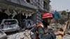 FILE - In this June 23, 2021, file photo, a rescue worker examines the site of explosion in Lahore, Pakistan. A Pakistani official said there is evidence linking India with acts of terrorism in Pakistan.