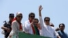 Ousted Pakistani Prime Minister Imran Khan gestures as he travels on a vehicle to lead a protest march to Islamabad, in Mardan, Pakistan, May 25, 2022.