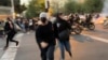 FILE - In this Sept. 19, 2022, photo taken by an individual not employed by the Associated Press and obtained by the AP outside Iran, women run away from anti-riot police during an anti-government protest in Tehran.