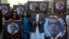 FILE - Members of a civil society group participate in a candlelight vigil in Lahore, Pakistan, on Dec. 9, 2021, to pay tribute to Sri Lankan factory manager Priyantha Kumara, who was accused of blasphemy and lynched by a Muslim mob in Sialkot, Pakistan.