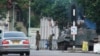 A military tank is seen with armed soldiers on a road leading to President Robert Mugabe's office in Harare, Zimbabwe, Nov. 15, 2017.