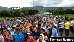 People cross the Colombian-Venezuelan border over the Simon Bolivar international bridge in Cucuta, June 10, 2019.