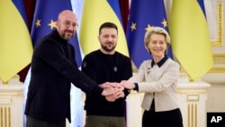 Ukrainian President Volodymyr Zelenskyy, center, European Commission President Ursula von der Leyen, right, and European Council President Charles Michel shake hands during the EU-Ukraine summit in Kyiv, Ukraine, Feb. 3, 2023. (Ukrainian Presidential Press Office via AP) 