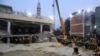 Rescue workers use a crane to lift a portion of a collapsed roof after a suicide blast in a mosque in Peshawar, Pakistan, Jan. 30, 2023.