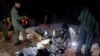 People inspect what Pakistani security sources say are the remains of a missile fired into Pakistan from India, near Mian Channu, Pakistan, March 9, 2022. (Pakistani security sources/Handout via Reuters)