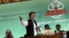 Pakistan's Prime Minister Imran Khan speaks at the start of a two-day gathering of the 57-member Organization of Islamic Cooperation, at the Parliament House in Islamabad, March 22, 2022.