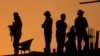 FILE - Pakistan police commandos stand guard on a rooftop while they observe the area to ensure the security of the rally of Pakistan's former Prime Minister Imran Khan's 'Pakistan Tehreek-e-Insaf' party, in Rawalpindi, Pakistan, Nov. 26, 2022. 