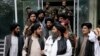 FILE - Mullah Abdul Ghani Baradar, acting deputy prime minister of the Afghan Taliban's caretaker government, center, and other Taliban officials attend a ceremony marking the 9th anniversary of the death of Mullah Mohammad Omar, Apr. 24, 2022.