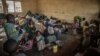 FILE - Internally displaced children, fleeing clashes between M23 rebels and Congolese soldiers, eat a meal prepared by volunteers in Kanyarushinya, north of Goma, May 27, 2022.
