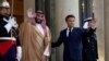 French President Emmanuel Macron and Saudi Crown Prince Mohammed bin Salman gesture ahead of a working dinner at the Elysee Palace in Paris, France, July 28, 2022. 