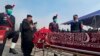 Pakistani Interior Minister Sheikh Rashid Ahmed, second left, pays tribute to a police officer, who was killed in an overnight attack, at a funeral prayer, in Islamabad, Pakistan, Jan. 18, 2022.