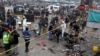 Police officials and investigators examine the site of bomb explosion, in Lahore, Pakistan, Jan. 20, 2022. 