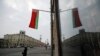 FILE: A Belarusian national flag flutters over a street in Minsk, Belarus, Feb. 16, 2022.