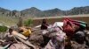 Afghan children sit among their salvaged belongings after an earthquake in Gayan village, in Paktika province, Afghanistan, Friday June 24, 2022. 