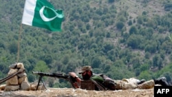 FILE - A Pakistani soldier takes position in Manatu mountain at the central part of Kurram Agency, Pakistan's tribal belt bordering Afghanistan, during an operation against militants, July 10, 2011. 