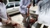 Somali man is carried away from scene of suicide bomb attack during university student graduation ceremony at a local hotel in Mogadishu, 3 Dec 2009