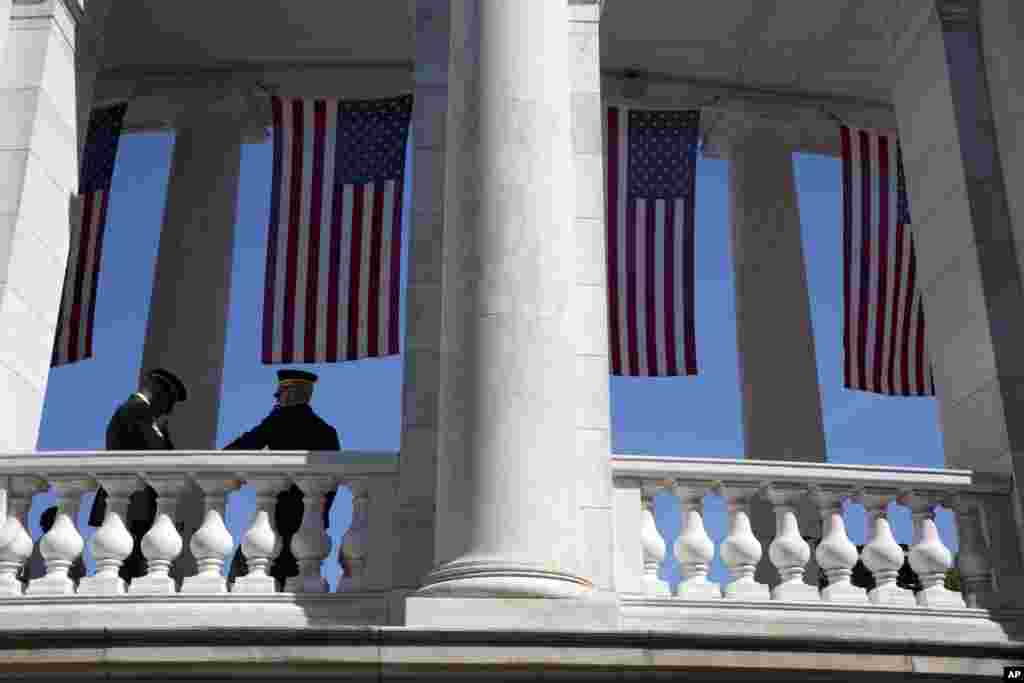 Military personnel wait for the beginning of a Memorial Day event at Arlington National Cemetery, May 26, 2014. 