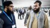 Hamed Safi (R), a member of Afghanistan's delegation, talks to his colleague during a break in a plenary session of the COP29 Summit in Baku on Nov. 11, 2024, on the opening day of the 2024 UN Climate Change Conference. 