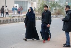 A student of Jamia Millia Islamia university leaves a day after police stormed their campus in New Delhi, Dec.16, 2019.