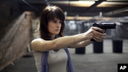 FILE - Maria Butina, a gun-rights activist, is seen at a shooting range in Moscow, Russia, April 22, 2012. 