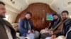 This handout photograph released by the Afghan Taliban and taken on Jan. 22, 2022 shows Taliban senior official member Anas Haqqani, right, and delegates sitting on a plane before departing to Oslo,