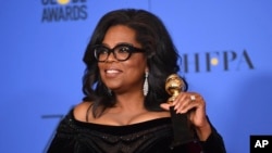 Oprah Winfrey poses in the press room with the Cecil B. DeMille Award at the 75th annual Golden Globe Awards at the Beverly Hilton Hotel on Jan. 7, 2018, in Beverly Hills, Calif.