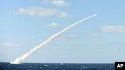In this undated photo released by the South Korean Defense Ministry on February 14, 2013, a South Korean sea-to-land cruise missile is fired from a submarine during a drill at an undisclosed location in South Korea.