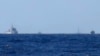 2014年7月15日南中国海地区，从远处可见护卫海洋石油981钻井平台的中国船只。