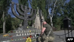 Український військовослужбовець єврейської національності бере участь у меморіальній церемонії з нагоди 82-х роковин Бабиного Яру масових розстрілів нацистами мирного населення, переважно євреїв, в окупованому Києві під час Другої світової війни. Київ, 29 вересня 2023 року. (AFP)