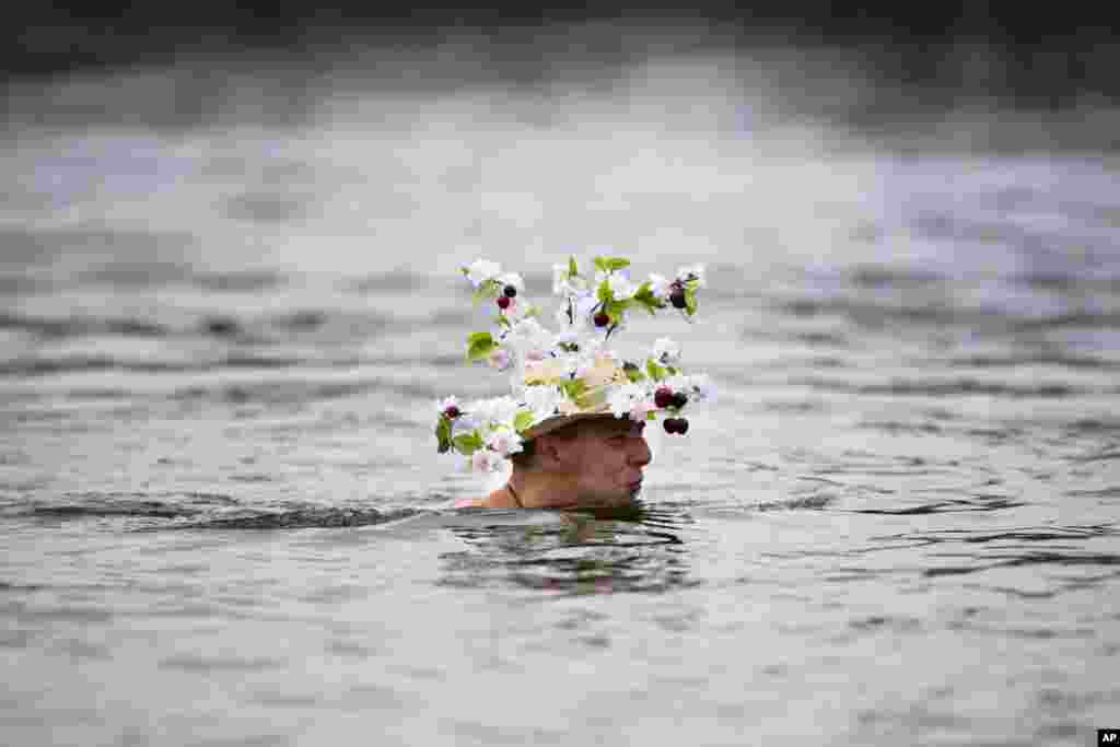 A man with a New Year's hat attends the annual New Year's Berliner Seehunde (Berlin Seals) swim at Oranke Lake, Berlin, Germany, Jan. 1, 2014.