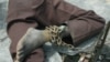 FILE - A patient at a home for the mentally ill is chained to a table in Monrovia, Liberia, Aug. 29, 2003.