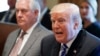 FILE - Secretary of State Rex Tillerson, left, listens as President Donald Trump speaks during a Cabinet meeting at the White House, Nov. 20, 2017, in Washington.