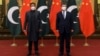 In this photo released by Xinhua News Agency, Chinese President Xi Jinping, right, and Pakistan Prime Minister Imran Khan pose for a photo before their bilateral meeting at the Great Hall of the People in Beijing, Feb. 6, 2022. 