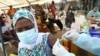 FILE - A resident receives a vaccine as the campaign against Ebola continues in Alakro, the slum where the first case of Ebola was confirmed, in Abidjan, Ivory Coast, August 17, 2021. 
