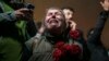 A woman cries as she and others gather in a moment of silence to mark the first anniversary of the country's catastrophic earthquake, in Antakya, Turkey, on Feb. 6, 2024.