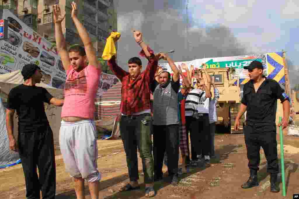 Egyptian security forces detain protesters as they clear a sit-in by supporters of ousted Islamist President Mohammed Morsi in the eastern Nasr City district of Cairo, Egypt, August 14, 2013.&nbsp;