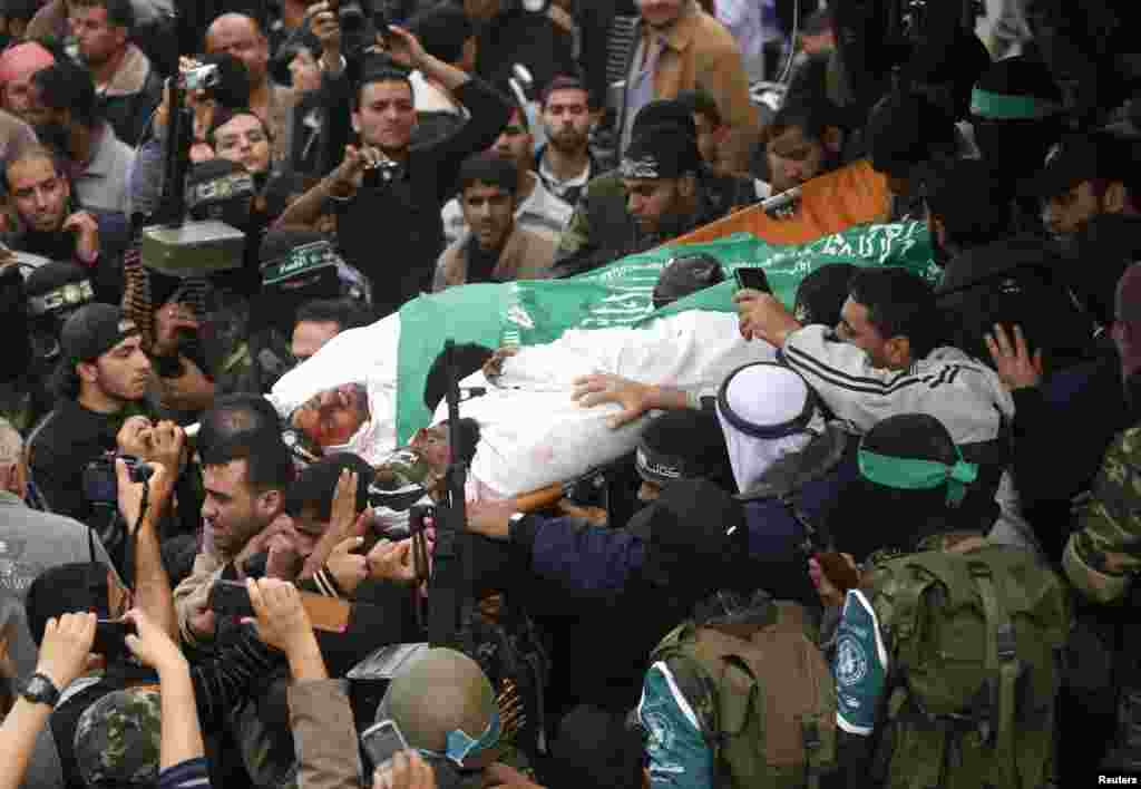 Hamas militants carry the bodies of their comrades, who medics said were killed in Israeli air strikes on Wednesday, during their funeral in the central Gaza Strip, November 22, 2012. 